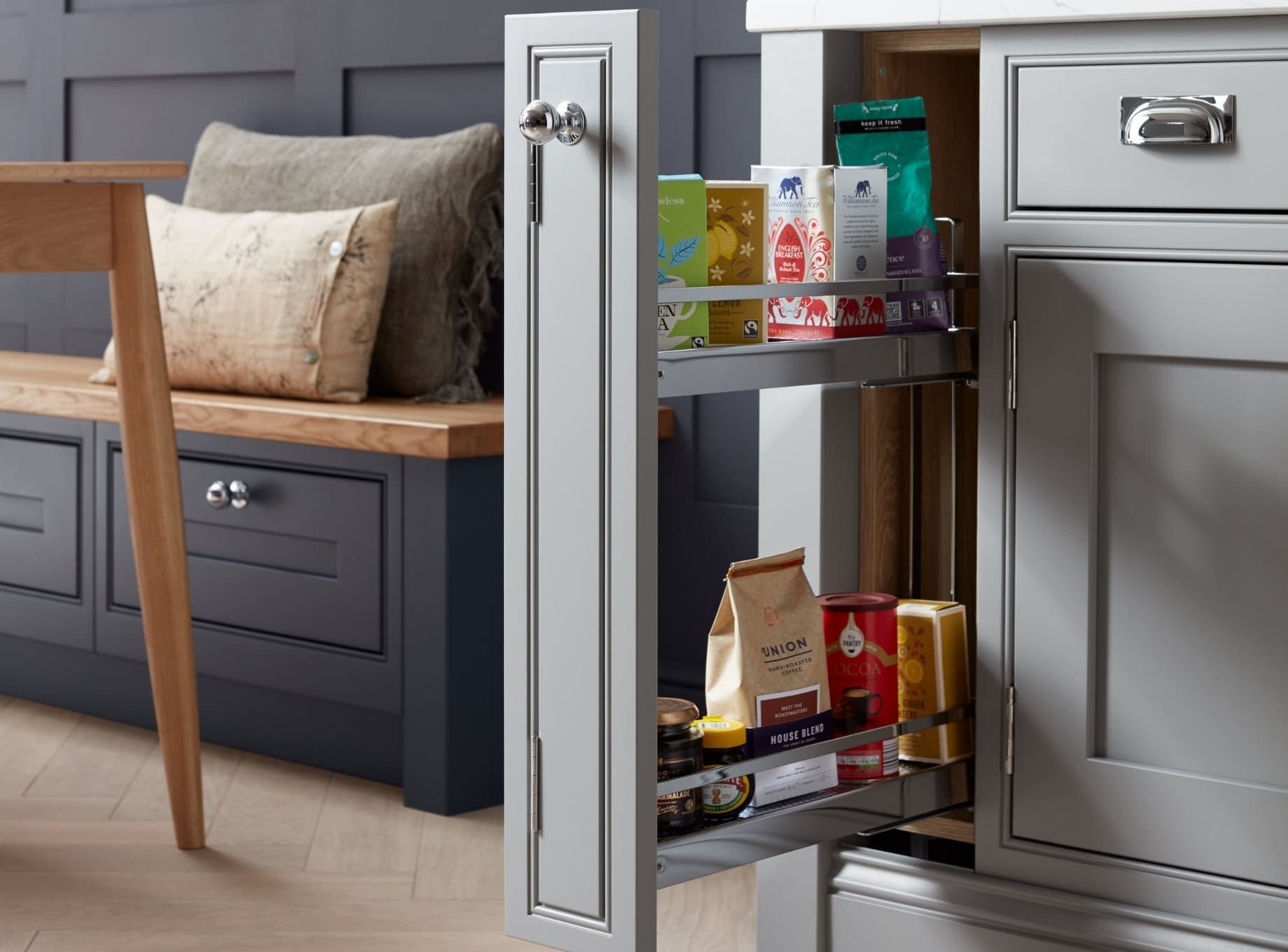 A vertical slide-out pantry drawer built into kitchen units